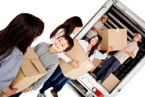 Customer booking a removal service with boxed household items and moving equipment