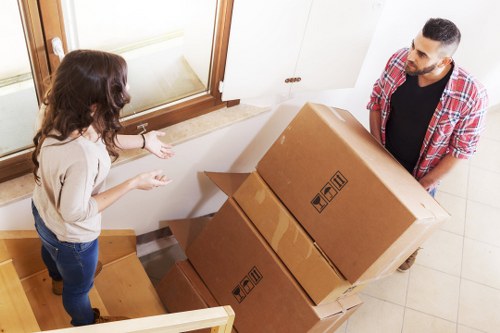 Workers using careful lifting methods during a removal job