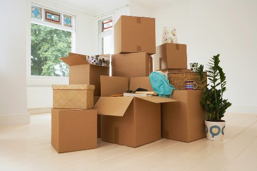 Packed office boxes and labelled furniture ready for relocation