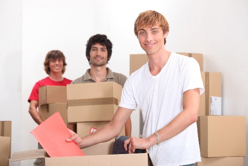 Local house removalists in Barnet carrying furniture safely down stairs